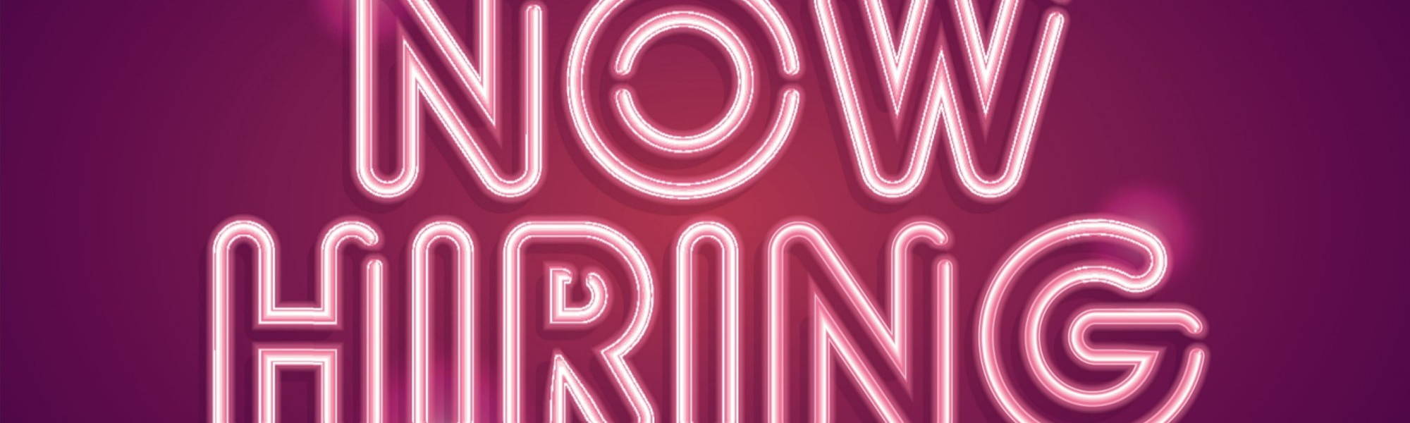 Now Hiring in Pink neon writing